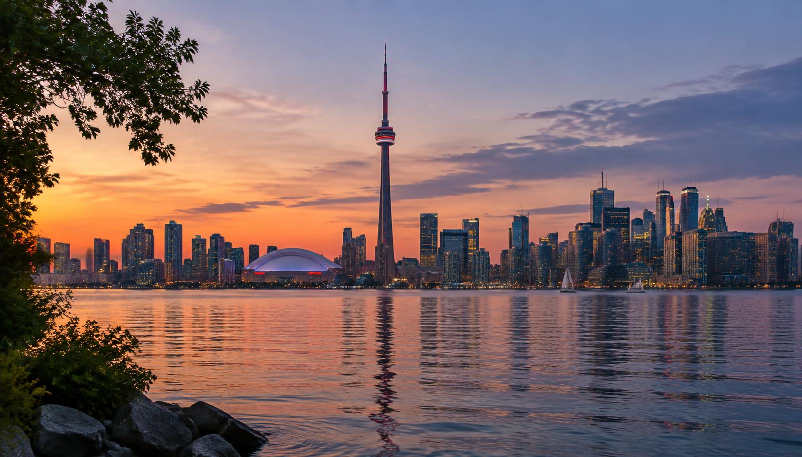 Toronto skyline and the CN Tower at dusk, seen across the water from the Toronto Islands